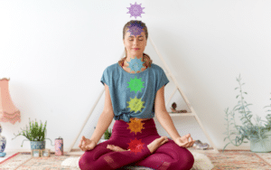 alt="woman with 7 chakras meditating"